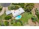 An aerial view showcases the home's swimming pool and large grassy backyard with mature trees and landscaping at 1298 E Buffalo St, Chandler, AZ 85225