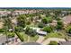 Aerial image of home with spacious green yard, mature trees, swimming pool, carport, and street view at 1298 E Buffalo St, Chandler, AZ 85225