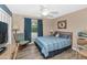 Cozy bedroom with hardwood floors, rocking chair, and a ceiling fan offers a relaxing retreat at 1298 E Buffalo St, Chandler, AZ 85225