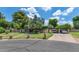 Charming single-story home with lush landscaping, mature trees, and a spacious two-car carport at 1298 E Buffalo St, Chandler, AZ 85225