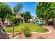 Spacious backyard oasis with a refreshing pool, mature landscaping, well-manicured lawn, and a covered patio area at 13005 W Vista Paseo Dr, Litchfield Park, AZ 85340