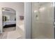 Ensuite bathroom with large tub and shower with glass doors, leading into primary bedroom at 13005 W Vista Paseo Dr, Litchfield Park, AZ 85340