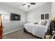 A cozy bedroom with neutral walls includes carpet, large windows with shutters, and a ceiling fan at 13005 W Vista Paseo Dr, Litchfield Park, AZ 85340