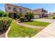 Beautiful home featuring a well-manicured lawn, mature trees, and a welcoming entrance at 13005 W Vista Paseo Dr, Litchfield Park, AZ 85340