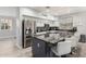 Bright kitchen featuring stainless steel appliances, dark countertops, and a spacious island with seating at 13005 W Vista Paseo Dr, Litchfield Park, AZ 85340