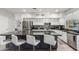 Stylish kitchen with white cabinets, dark countertops, and stainless steel appliances at 13005 W Vista Paseo Dr, Litchfield Park, AZ 85340