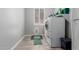 A laundry room with tile floor, window with shutters, and newer washer and dryer at 13005 W Vista Paseo Dr, Litchfield Park, AZ 85340
