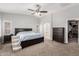 Spacious main bedroom with carpet flooring, ceiling fan, ensuite, and walk-in closet at 13005 W Vista Paseo Dr, Litchfield Park, AZ 85340