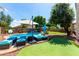 A well-maintained backyard pool with comfortable lounge chairs and a putting green at 13005 W Vista Paseo Dr, Litchfield Park, AZ 85340