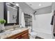 Bathroom featuring a single sink vanity with granite countertop, grey walls and white tiled shower at 1314 S Bridgegate Dr, Gilbert, AZ 85296