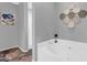 Bathroom with a tub, tiled floors, grey walls and modern decor at 1314 S Bridgegate Dr, Gilbert, AZ 85296