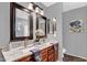 Bathroom featuring dual sinks, granite counters, wood cabinets and a vanity at 1314 S Bridgegate Dr, Gilbert, AZ 85296