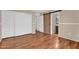 Spacious bedroom with wood laminate floors, closet and barn door access to the bathroom at 1314 S Bridgegate Dr, Gilbert, AZ 85296