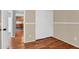 Bedroom with light tan walls, white trim, a closet with sliding doors and wood-look floors at 1314 S Bridgegate Dr, Gilbert, AZ 85296