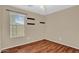Bedroom with light tan walls, white trim, window with blinds and wood-look floors at 1314 S Bridgegate Dr, Gilbert, AZ 85296