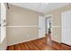 Bedroom featuring light tan walls, white trim and wood-look floors at 1314 S Bridgegate Dr, Gilbert, AZ 85296