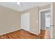 Bedroom with light tan walls, white trim, closet with sliding doors and wood-look floors at 1314 S Bridgegate Dr, Gilbert, AZ 85296