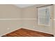Bedroom with light tan walls, white trim, a window with blinds and wood-look floors at 1314 S Bridgegate Dr, Gilbert, AZ 85296