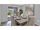 Cozy dining area featuring a modern wood table, comfortable seating and sliding glass doors to the backyard at 1314 S Bridgegate Dr, Gilbert, AZ 85296