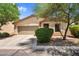 Charming single-story home with a two-car garage, desert landscaping, and a welcoming entrance at 1314 S Bridgegate Dr, Gilbert, AZ 85296