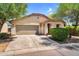 Charming single-story home with a two-car garage, desert landscaping, and a welcoming entrance at 1314 S Bridgegate Dr, Gilbert, AZ 85296
