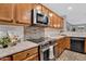Updated kitchen with stainless steel appliances, tile backsplash, and wooden cabinets at 1314 S Bridgegate Dr, Gilbert, AZ 85296