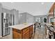 Modern kitchen with stainless steel appliances, a center island, and access to the dining area at 1314 S Bridgegate Dr, Gilbert, AZ 85296