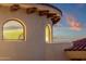 Close-up of the rounded turret architecture with stucco walls and arched windows at 15536 E Heavenly Vista Trl, Fountain Hills, AZ 85268