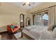 This bedroom features a bed, hardwood floors, a sitting chair, a balcony view, and ensuite bath access at 15536 E Heavenly Vista Trl, Fountain Hills, AZ 85268