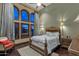 Spacious bedroom with high ceilings, large arched windows, hardwood floors, and custom lighting fixtures at 15536 E Heavenly Vista Trl, Fountain Hills, AZ 85268