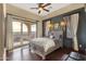 Spacious bedroom with dark accent wall, gray color palette, hardwood floors, and views of the mountains at 15536 E Heavenly Vista Trl, Fountain Hills, AZ 85268