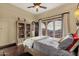 Bedroom with balcony access, hardwood floors, a bookcase, a ceiling fan, and views of the mountains at 15536 E Heavenly Vista Trl, Fountain Hills, AZ 85268