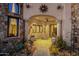 Charming covered patio with a swing, decorative planters, and stone pathway leading to the entrance at 15536 E Heavenly Vista Trl, Fountain Hills, AZ 85268