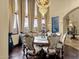 Elegant dining room featuring a dazzling chandelier, six chairs, and large windows with scenic views at 15536 E Heavenly Vista Trl, Fountain Hills, AZ 85268