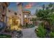 Exterior of a luxurious estate featuring manicured landscaping, stone accents, and an arched entryway at 15536 E Heavenly Vista Trl, Fountain Hills, AZ 85268