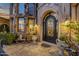 Ornate front door with decorative stonework and lush landscaping creating a grand entrance at 15536 E Heavenly Vista Trl, Fountain Hills, AZ 85268