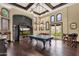 Entertaining game room with ping pong table, built-in entertainment center, and backyard access at 15536 E Heavenly Vista Trl, Fountain Hills, AZ 85268