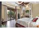 This main bedroom features a fireplace, tray ceiling, hardwood floors, and a balcony with an incredible view at 15536 E Heavenly Vista Trl, Fountain Hills, AZ 85268