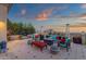 Stylish outdoor patio area with comfortable seating, a fire pit, and views of the surrounding landscape at 15536 E Heavenly Vista Trl, Fountain Hills, AZ 85268