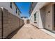 View of the new home's backyard, featuring a stucco wall, and a wooden gate at 15593 S 180Th Ln, Goodyear, AZ 85338