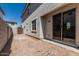 View of the new home's backyard, featuring a stucco wall, sliding glass doors, and a wooden gate at 15593 S 180Th Ln, Goodyear, AZ 85338
