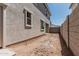 View of the new home's backyard, featuring stucco and block walls and a ground cover of dirt at 15593 S 180Th Ln, Goodyear, AZ 85338