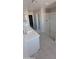 Bathroom featuring double sinks, a glass shower, and tiled flooring, providing a luxurious feel at 15593 S 180Th Ln, Goodyear, AZ 85338