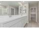 Modern bathroom featuring a double vanity with white cabinets and a large mirror at 15593 S 180Th Ln, Goodyear, AZ 85338
