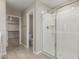 Bright bathroom with a glass-enclosed shower and access to a walk-in closet at 15593 S 180Th Ln, Goodyear, AZ 85338