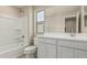 Bathroom featuring a shower-tub combo and vanity with a window for natural light at 15593 S 180Th Ln, Goodyear, AZ 85338