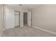 Cozy bedroom featuring a closet with sliding doors and neutral colored carpet at 15593 S 180Th Ln, Goodyear, AZ 85338