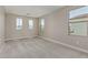 Bedroom with neutral carpet and paint with bright natural light from windows at 15593 S 180Th Ln, Goodyear, AZ 85338