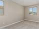 Bedroom featuring carpet and two windows providing natural light at 15593 S 180Th Ln, Goodyear, AZ 85338