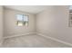 Bedroom with neutral walls and carpet, and two windows offering natural light at 15593 S 180Th Ln, Goodyear, AZ 85338